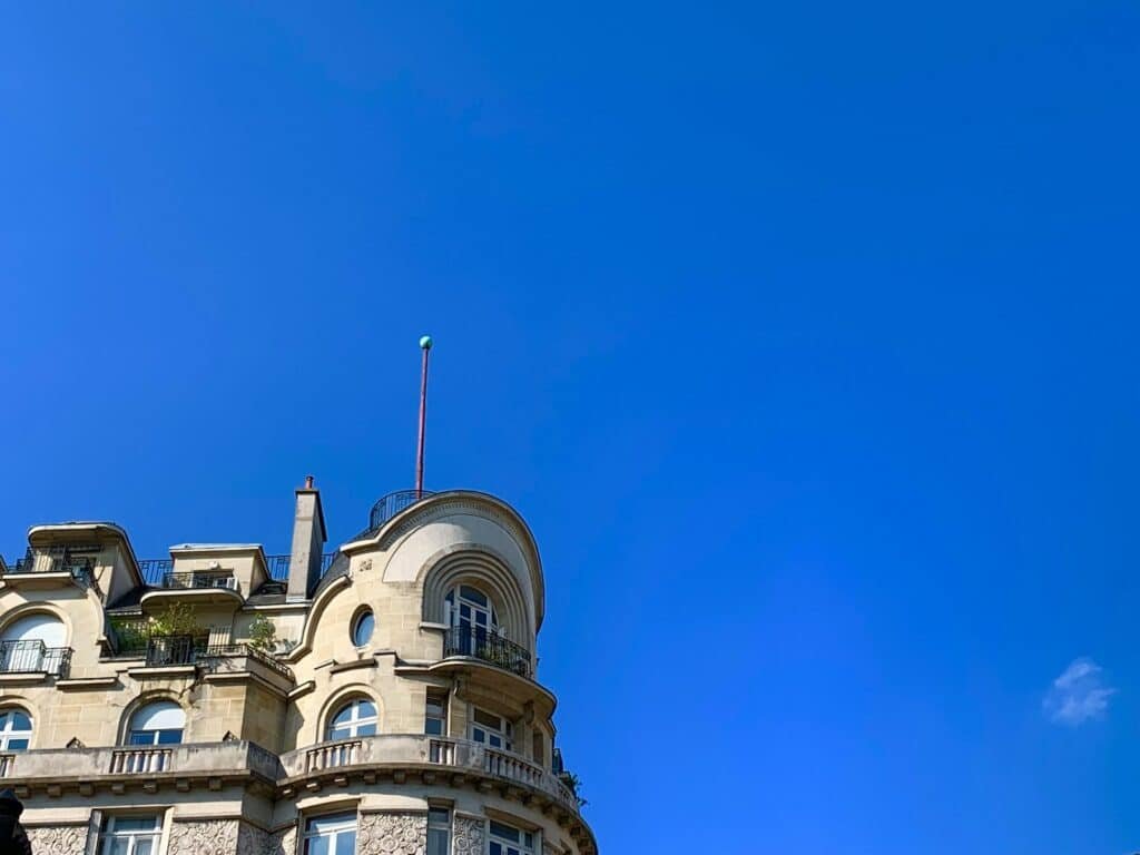 a tall building with a flag on top of it