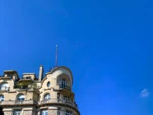 a tall building with a flag on top of it